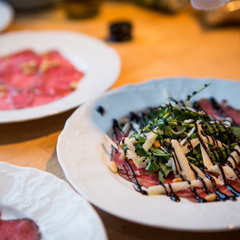 Beef carpaccio served with rocket salad, parmesan, truffle oil