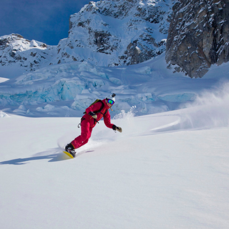 Heli snowboarding through the broken glacier serac’s on the East Coast of Greenland where our heli-skiing programs are based in Kulusuk.