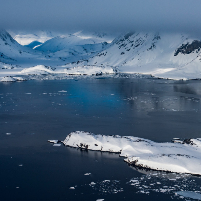 East Greenland heli-skiing. Dark waters of an ice free fjord near Kulusuk on the East Coast of Greenland where our heliskiing base is located.  ©Eli Spiegel