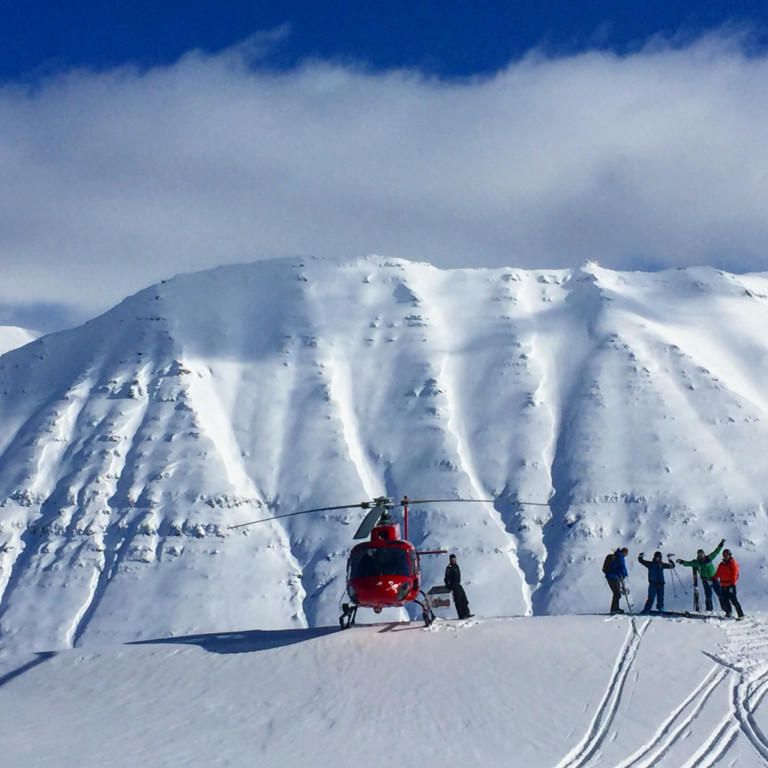 A group of skiers enjoying heli skiing in the Troll Peninsula