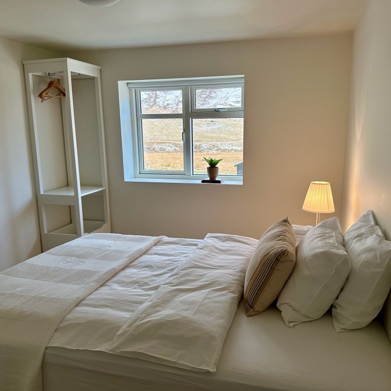 One of 3 bedrooms on lower floor of main house with a shared bathroom. Intended for guests requiring single room.