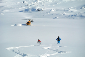 Heli-skiing towards the waiting helicopter in Northern Sweden