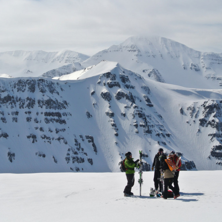 Skiers prepare themselves for skiing down to the valley