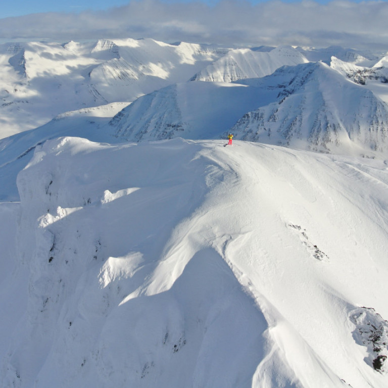 Lone Skier atop one of the many peaks on the Troll Peninsula in North Iceland